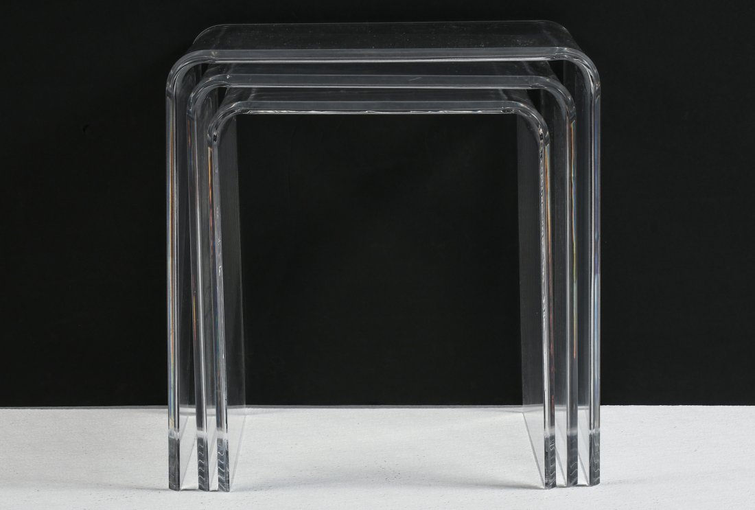 LUCITE NESTING TABLES: LUCITE NESTING TABLES: Set of three clear Lucite nesting tables. Iconic, 70's minimal waterfall design with beveled edges. Largest is approx. 17.5" h x 17" w x 12" d.
