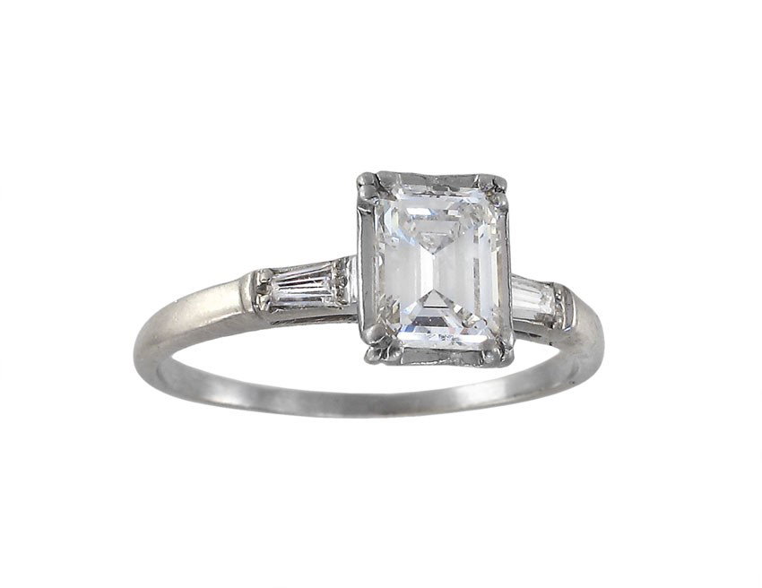 PLATINUM .80 CT EMERALD DIAMOND RING: PLATINUM .80 CT DIAMOND SOLITAIRE RING CA. 1930'S: Platinum ring centers a emerald cut diamond of approx. .80 Ct, 6.21 mm x 4.83 mm., VVS2 clarity and G color. Two baguette cut diamonds flank the cent