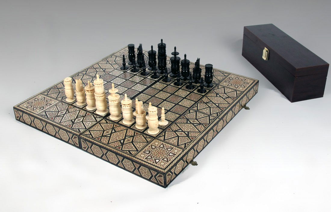 IVORY CHESS SET WITH INLAID BOX: IVORY CHESS SET WITH INLAID BOX: Complete carved ivory chess set, kings 4 1/2" h. Sold with profusely inlaid game board box with backgammon interior. Box measures 3 3/4" x 20 1/2" x 10 1/2".