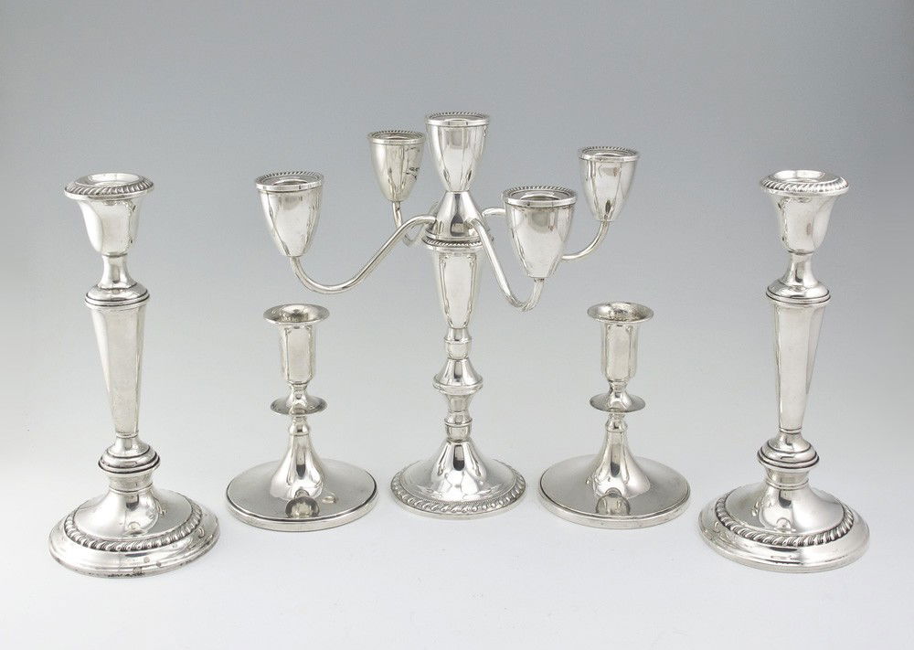 COLLECTION OF WEIGHTED STERLING CANDLESTICKS: COLLECTION OF WEIGHTED STERLING CANDLESTICKS: To include 1) Pair of Gorham single light sticks, 8 3/4" h. x 4" dia. 2) Pair of Baldwin & Miller single light sticks, 4 3/4" h. x 4" dia. 3) Duchin 5 lig