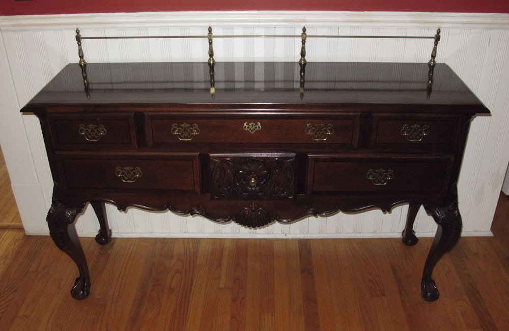 STANLEY FURNITURE CHIPPENDALE STYLE SIDEBOARD: STANLEY FURNITURE CHIPPENDALE STYLE SIDEBOARD: Brass back rail, 3 drawers over 3 drawers with lower center door carved. Brass hardware. Carved and shaped skirt, carved legs ending in claw and ball fee