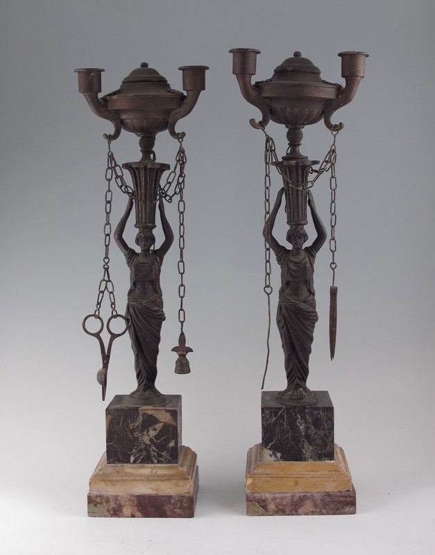 PAIR OF FIGURAL 3 LIGHT OIL LAMPS: PAIR OF FIGURAL 3 LIGHT OIL LAMPS: Pair of cast metal maidens holding urn form 3 light lamps. Each lamp has accessories hanging from chains. On marble bases 19" h. x 4 1/2" square base.
