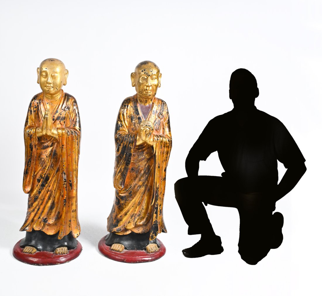 PAIR 19TH-CENTURY CARVED & GILT PRAYING BUDDHISTS: PAIR 19TH-CENTURY CARVED & GILT PRAYING BUDDHISTS: Burmese origin. Comprising; 1- Statue of Kasyapa, with hands clasped. 1- Statue of Ananda or Shariputra. Largest 42'' h.
