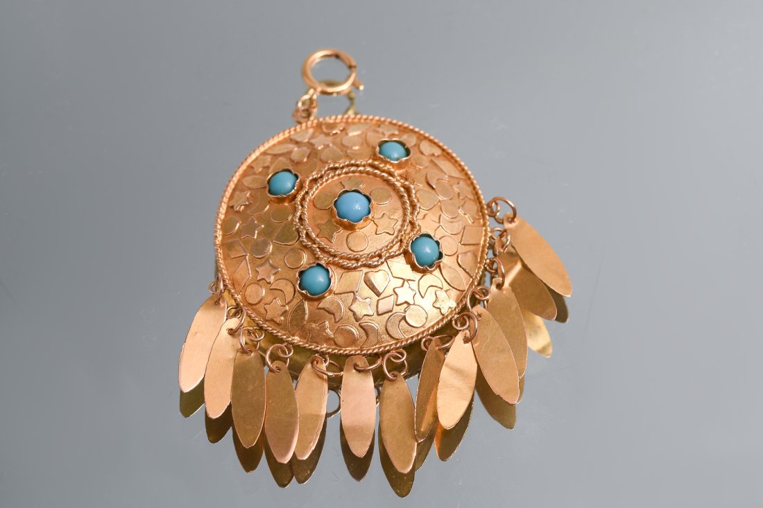 14K YELLOW GOLD AND TURQUOISE PENDANT: 14K YELLOW GOLD AND TURQUOISE PENDANT: 14K yellow gold domed disc is detailed with hearts, starts, moon, sun and other shapes, set with five cabochon turquoise stones and further detailed with 13 feat