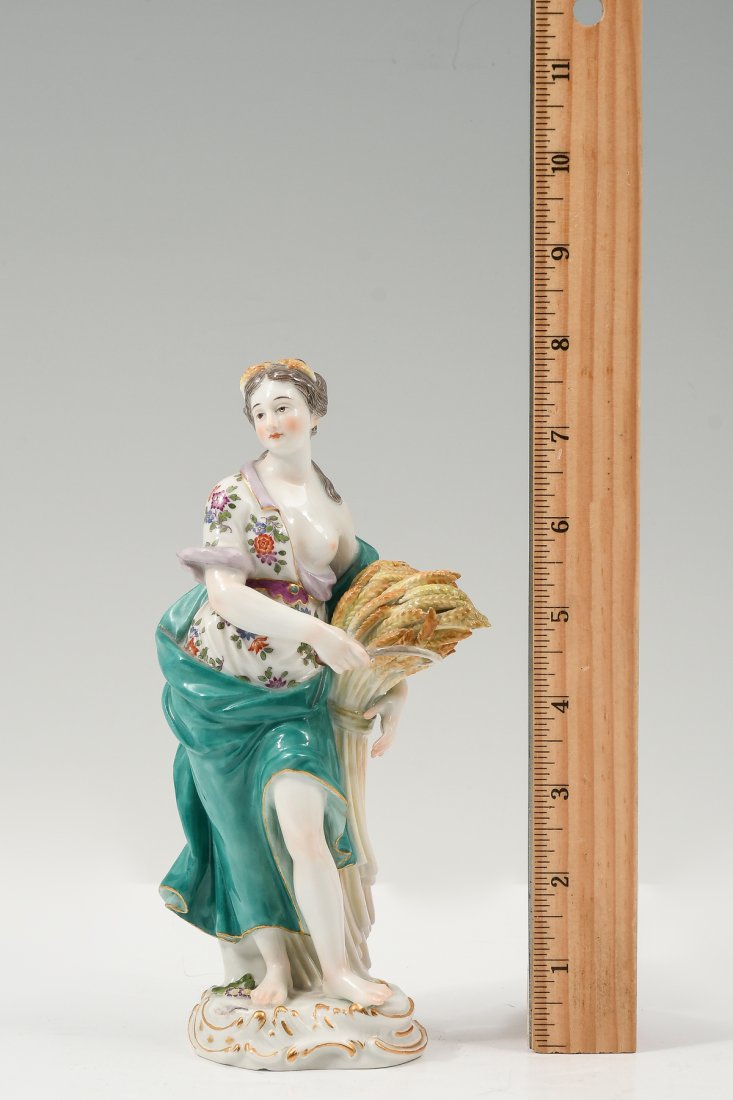 MEISSEN ALLEGORICAL FIGURE HOLDING SHEAF OF WHEAT: MEISSEN ALLEGORICAL FIGURE HOLDING SHEAF OF WHEAT: Meissen porcelain allegorical Autumn figure holding a scythe and sheath of wheat. Finely detailed polychrome enamel and gilding on a modeled base. Wi