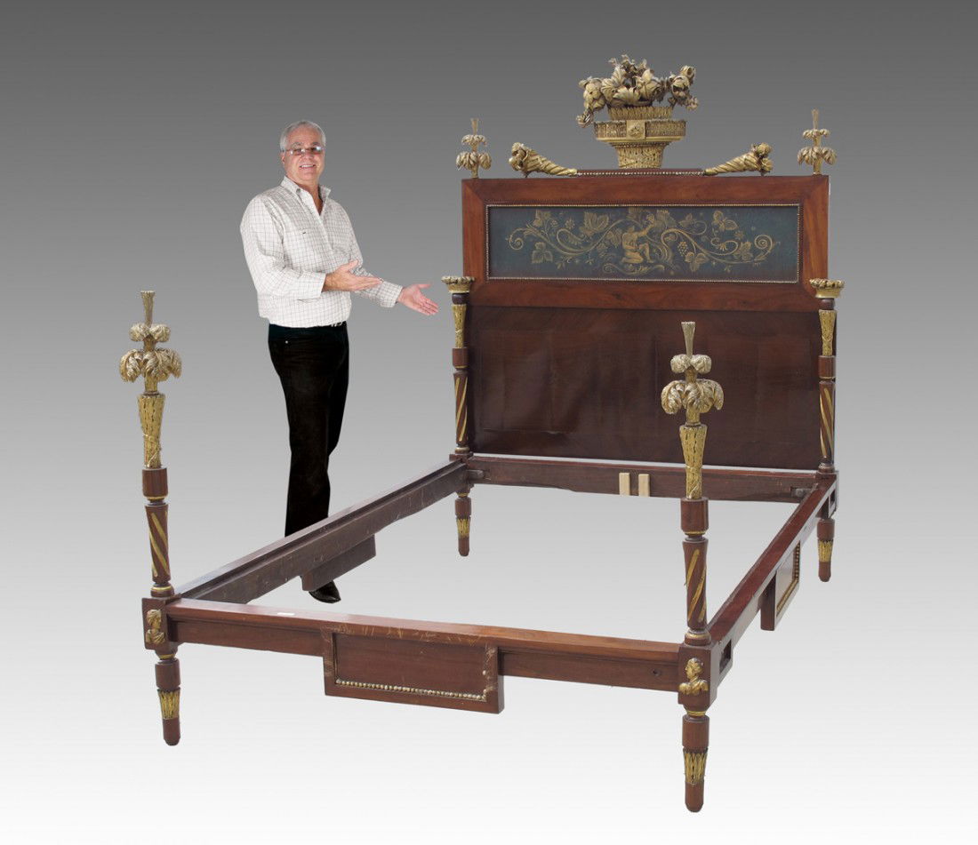 ORNATE FRENCH EMPIRE PERIOD BED: EARLY FRENCH PERIOD CARVED GILT WOOD AND GESSO BED: Headboard with urn and flower crest, foliate finials over inset panel with Bacchus scene. 6' 8" h. x 58 1/2". Footboard with foliate finials and fig