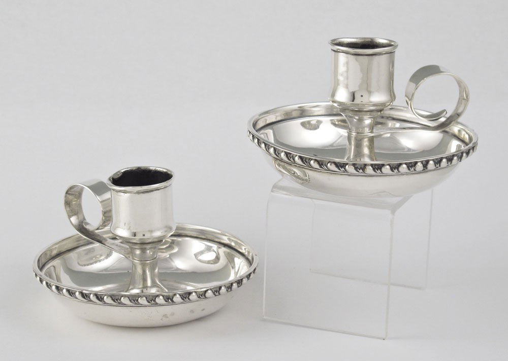 PAIR MAUSER STERLING CANDLE STANDS: PAIR MAUSER STERLING CANDLE STANDS: Pair single light sterling candle stands by Mauser Manufacturing Co.. Marked with Mauser mark, Sterling 1061. Monogrammed and dated 1895 under base. 2 1/4'' h. x 3 