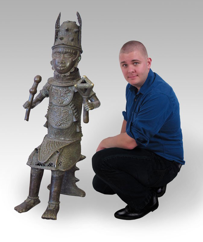 LARGE BENIN WARRIOR AFRICAN METAL FIGURE SCULPTURE: LARGE AFRICAN BENIN FIGURE SCULPTURE: Representing a warrior in full regalia, geometric weapon. Approx. 4' x 18'' x 2'