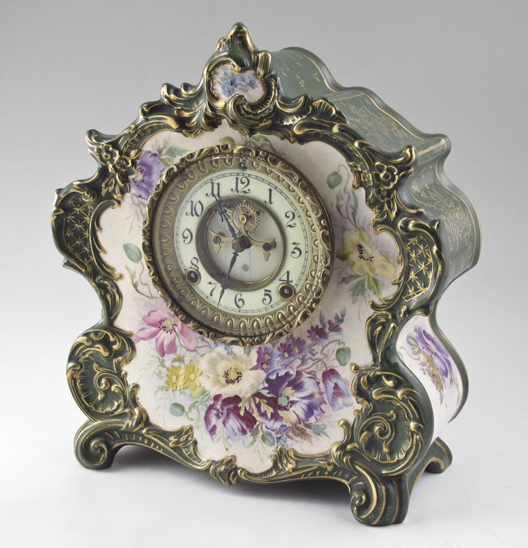 ANSONIA ROYAL BONN PORCELAIN CASE CLOCK: ANSONIA ROYAL BONN PORCELAIN CASE CLOCK: ''La Vogue'' Royal Bonn floral case with dark green trim and gold accents. Porcelain face with open escapement, Ansonia key and pendulum, time and strike movem