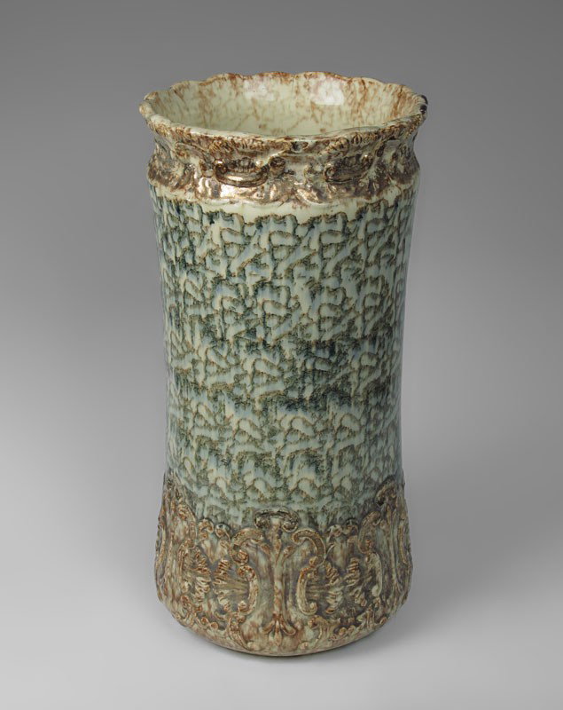 SPONGE DESIGN POTTERY UMBRELLA STAND: SPONGE DESIGN POTTERY UMBRELLA STAND: Scalloped rim with green / gold sponge design. Unmarked. 21 1/2" h. x 11" dia.