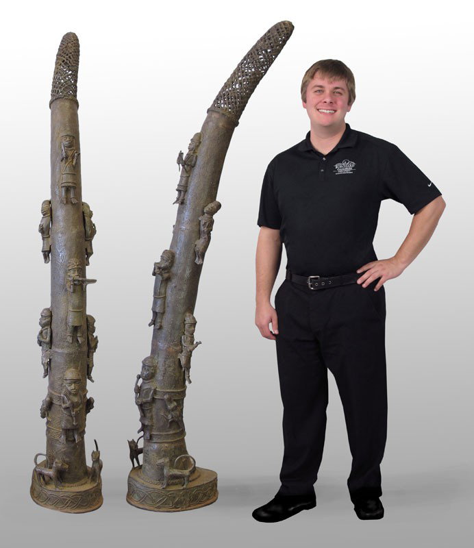 PAIR BENIN AFRICAN BRONZE ALTAR TUSKS SCULPTURE: PAIR BENIN AFRICAN BRONZE ALTAR TUSKS SCULPTURE: Approx. 72 1/2" x 11" x 20" each.