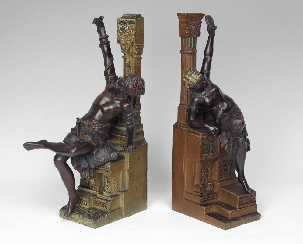PAIR FIGURAL BLACKAMOOR MANTLE GARNITURE: PAIR FIGURAL BLACKAMOOR MANTLE GARNITURE: Cast metal bases with bronzed figures of man holding snake on one, semi nude woman holding tambourine on other. 17" h. x 9 1/4" x 7".