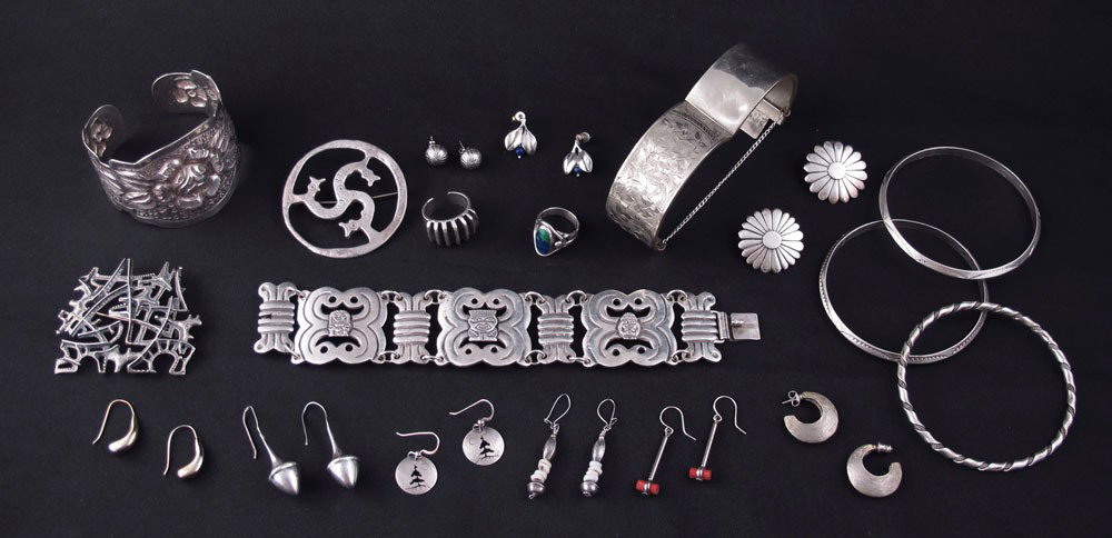 WORLDLY COLLECTION OF STERLING SILVER JEWELRY: WORLDLY COLLECTION OF STERLING SILVER JEWELRY: To include 9 pairs of earrings, 2 brooches or pins, 2 rings, 3 bangle bracelets, repousse floral bracelet, Incan motif 900 silver bracelet, unmarked cuff