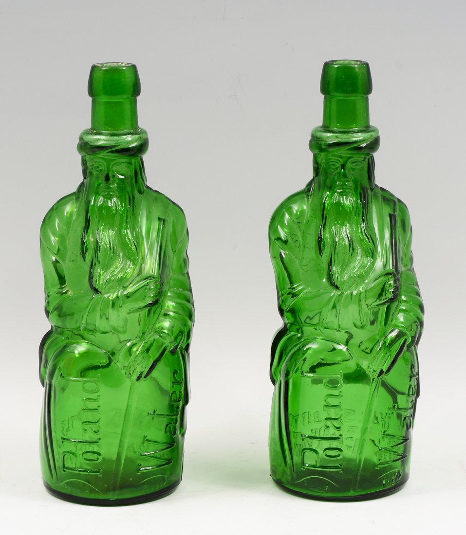 PR. POLAND WATER MOSES BOTTLES: PR. POLAND WATER MOSES BOTTLES: Two Poland Water Moses emerald green glass "Honeymoon" bottles c. 1931. Both read "Poland Water" at front, and on the back a circular emblem reads "Poland Mineral Sprin