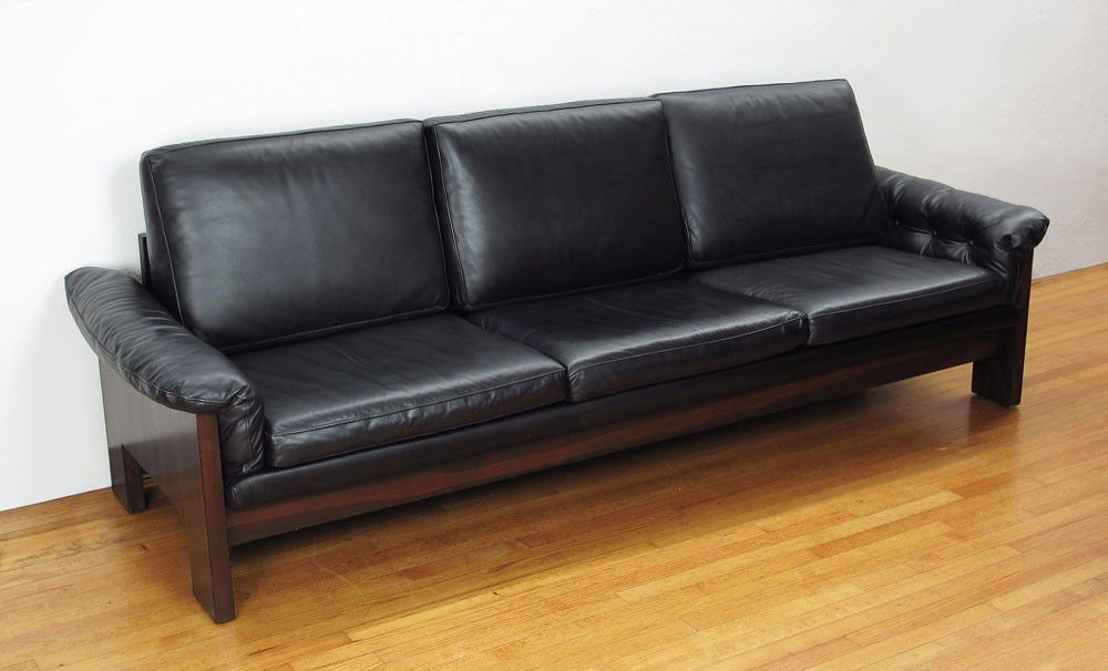 MILO BAUGHMAN ROSEWOOD & LEATHER SOFA: MILO BAUGHMAN ROSEWOOD AND BLACK LEATHER SOFA: Rosewood back, sides and skirt with black leather cushions. 26" h. x 97" x 34 1/2".