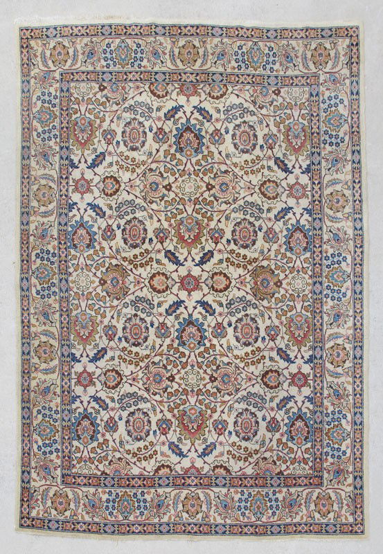 PERSIAN TABRIZ SEMI-ANTIQUE HAND KNOTTED WOOL RUG: PERSIAN TABRIZ SEMI-ANTIQUE HAND KNOTTED WOOL RUG, : This beautiful rug has an ivory field and border with a well-drawn design of palmettes, flower heads, and leaves connected by an overall vine that