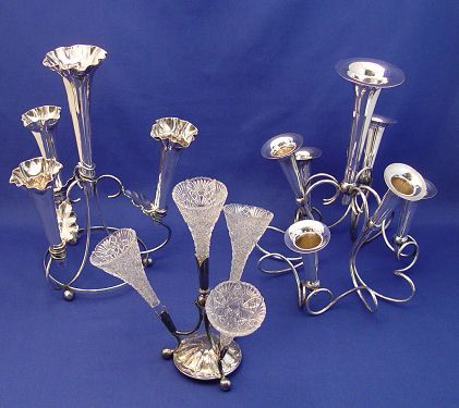 GROUP OF 3 SILVERPLATE EPERGNE VASES: GROUP OF 3 SILVERPLATE EPERGNES: 1) An elaborately curved six arm epergne with 6 trumpet horn vases, 12"h., no makers mark. 2) An English four vase epergne with pressed glass trumpet vases, maker JD &