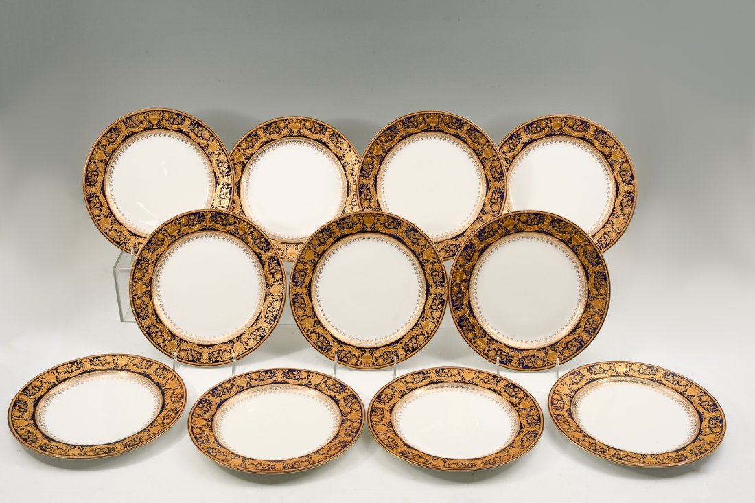 11 PC. ROYAL WORCESTER GOLD DECORATED PLATES: 11 PC. ROYAL WORCESTER GOLD DECORATED PLATES: Royal Worcester set of 11 plates with heavily gilt enamel floral/urn pattern on a cobalt blue band. With red Royal Worcester backstamps, having four dots