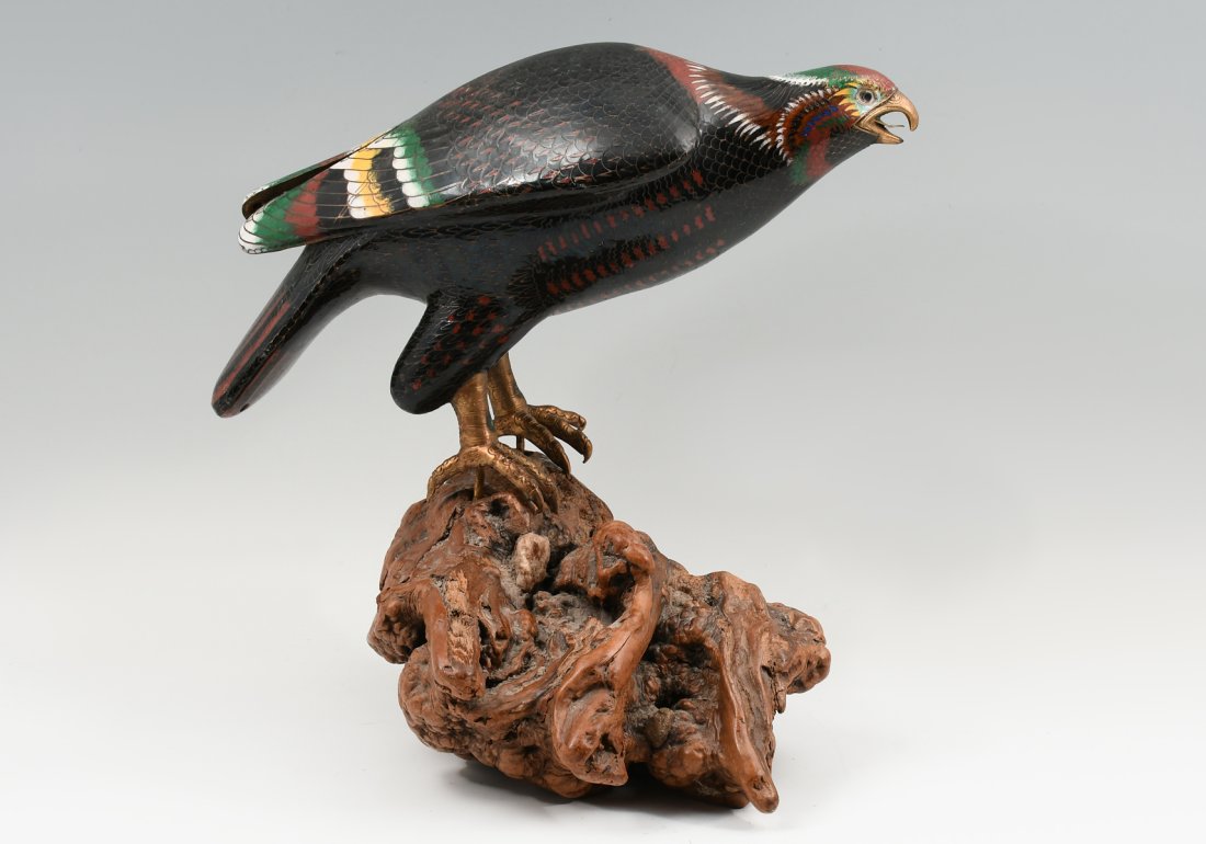 LARGE CHINESE CLOISONNE FALCON ON WOODEN BASE: LARGE CHINESE CLOISONNE FALCON ON WOODEN BASE: A cloisonne enameled falcon perched upon an organic burlwood base. Approx. 16" h x 15" w x 13" d.