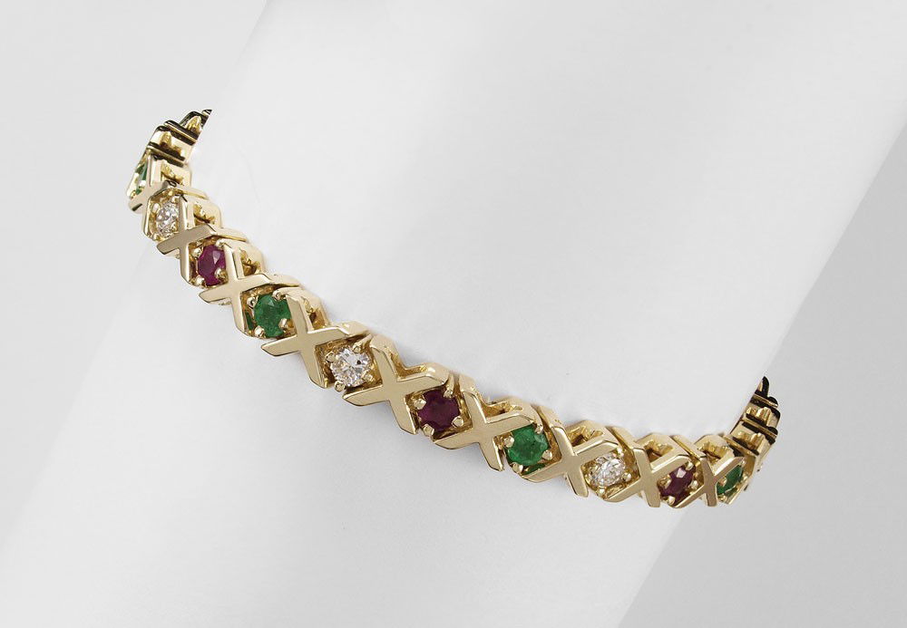 GOLD DIAMOND, RUBY & EMERALD BRACELET 24 GR 7''l.: 14K YELLOW GOLD, DIAMOND, EMERALD AND RUBY BRACELET: X O line bracelet of diamonds, emeralds and rubies. 8 round brilliant diamonds, total approx. 1.0 Ct., VS in clarity and H-I color. 7 round mixed c