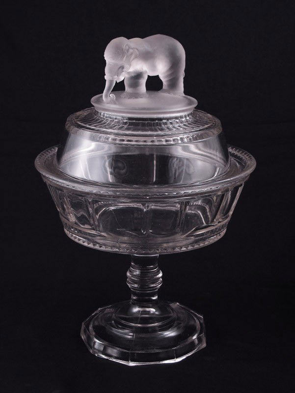 EAPG GLASS JUMBO PEDESTAL COMPOTE W/ ELEPHANT 12'': EAPG ''JUMBO'' COVERED PEDESTAL COMPOTE: Early American Pattern Glass pattern honoring PT Barnum and the elephant named Jumbo. Approx. 12'' h. x 8'' dia.