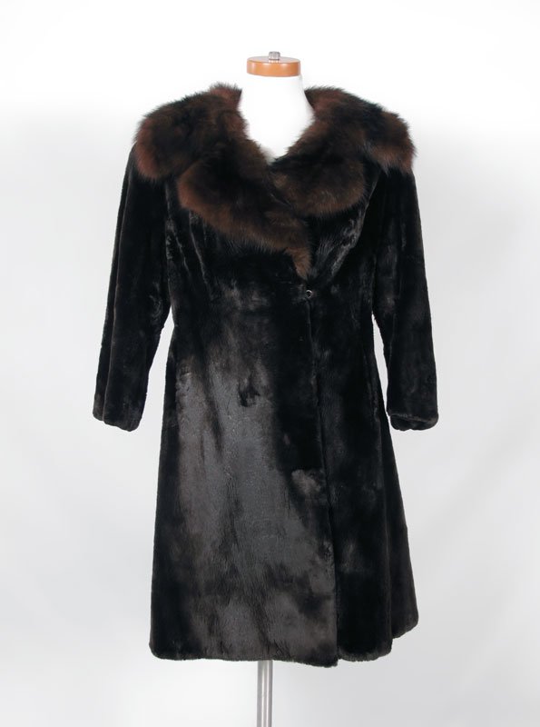 FULL LENGTH SEAL COAT WITH FOX COLLAR: FULL LENGTH SEAL COAT WITH FOX COLLAR: Dark brown seal fur with dark red fur collar and lapel. Bell sleeves, slits for the snap belt, Georgeou Westchester label. Measures approx. 38"l. x 18" shoulder 