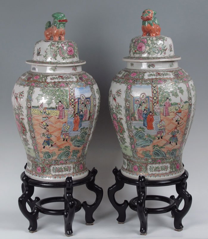 27 " PAIR LARGE CHINESE COVERED JARS SIGNED: PAIR LARGE CHINESE COVERED JARS ON STANDS: Signed in characters. Surmounted by foo dog finials. Approx. 27" tall, in the rose medallion colors. The black stands add 9" to the height.