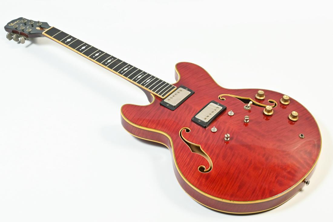 RED VESTA GRAHAM CUSTOM 335 ELECTRIC GUITAR IN CASE: RED VESTA GRAHAM CUSTOM 335 ELECTRIC GUITAR IN CASE: Beautifully grained Crimson red body with a Mother of Pearl inlaid neck. Banded body & neck. Resting in a Gator hard case. Untested. Approx. 42.5"