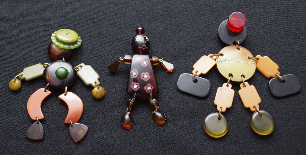 3 JIGGLY CRIB TOY FIGURES: 3 JIGGLY CRIB TOY FIGURES: 1) Bell hop, 5"l. 2) Bow legged person with green hat, 4 3/4". 3) Translucent root beer woman with painted detail, 4 1/2" (she used to have a pin back).