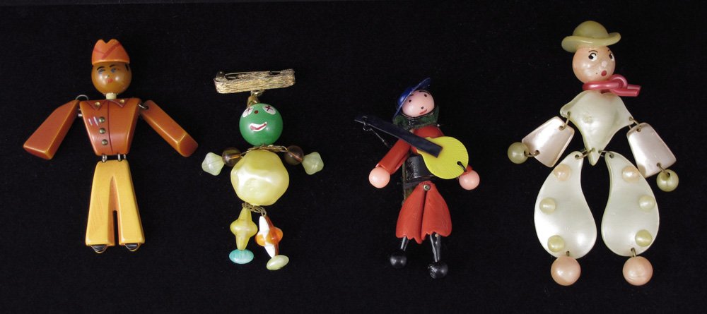 4 JOINTED PEOPLE PINS COWBOY BELL HOP GUITAR: 4 JOINTED PEOPLE PINS: 1) Bakelite bell hop, 3.5" 2) Pink and cream cowboy, 4 1/2". 3) A lady guitarist wit bending knees, 3 1/2". 4) Citrus colored clown, 3".