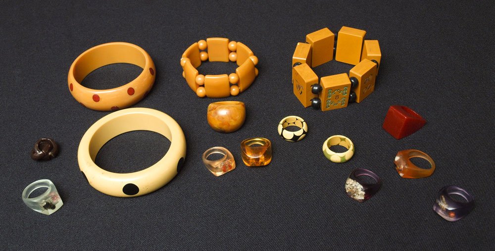 14 pc BAKELITE BRACELETS & LUCITE: 14 pc BAKELITE BRACELET AND RING LOT: 2 dot bangle bracelets, a Mah Jong bracelet, and a tile and bead stretch bracelet. The ten rings include polka dot, Lucite bug rings and a chunky red Bakelite rin