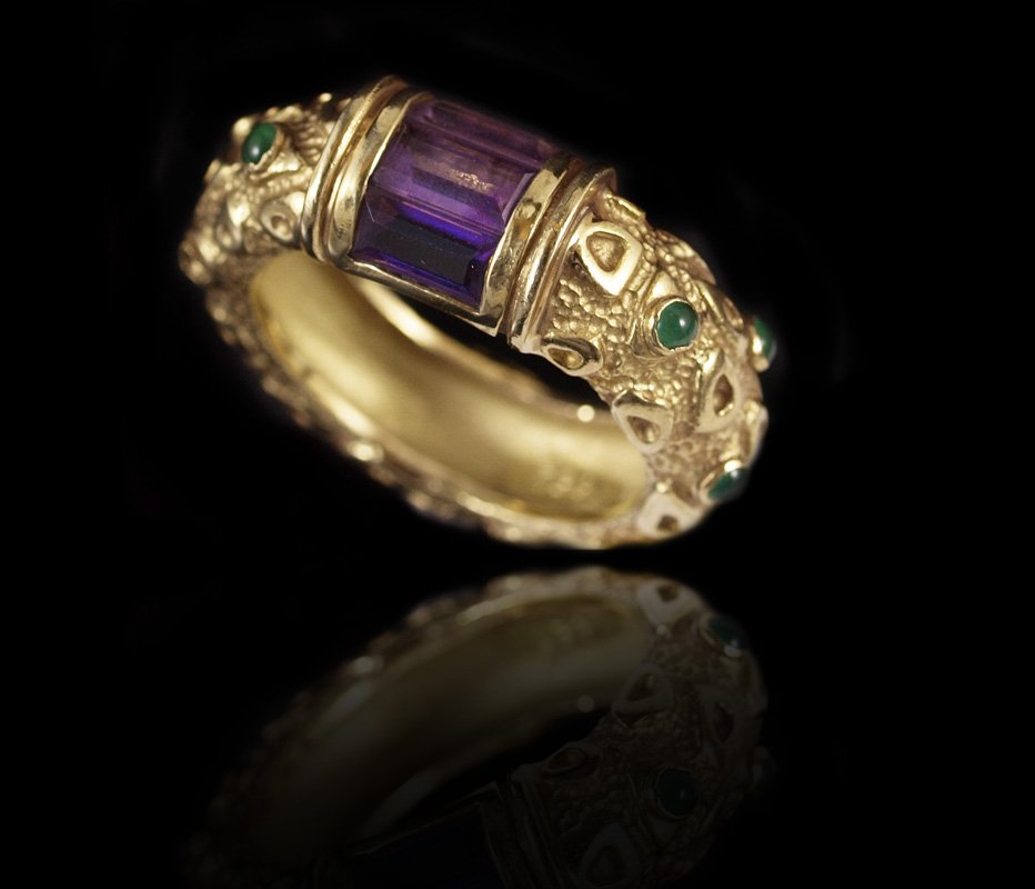 18k AMETHYST & EMERALD BAND RING 8.2 GRAMS SZ 6: 18K AMETHYST & EMERALD RING: 18K yellow gold ring contains three emerald cut amethysts. Weight: 1.00 Ct. Approx. 6 Round cabochon cut emeralds. Weight: .15 Ct. approx. The amethysts are channel set. T