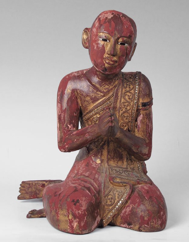 17" tall THAI CARVED WOOD BUDDHIST DEVOTEE: LARGE THAI BUDDHIST DEVOTEE: Carved wood with surface damage, crack, and loss of paint and gilding, though there are remains of the red pigment and gold. Approx. 17" x 15" x 12". Age unknown.