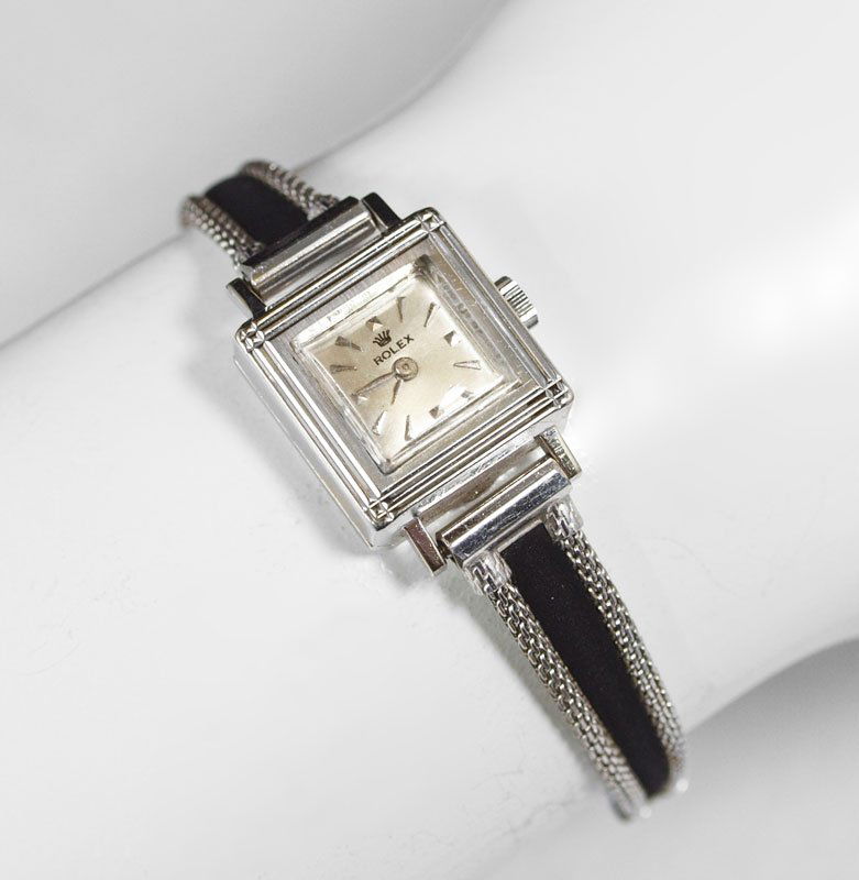 LADIES ROLEX 14K WHITE GOLD DRESS WATCH: LADIES 14K ROLEX DRESS WATCH CA. 1960: 14k white gold case, 17 jewel mechanical Swiss made Rolex movement in running order. The gold filled band with safety chain is not original. The case is hallmark