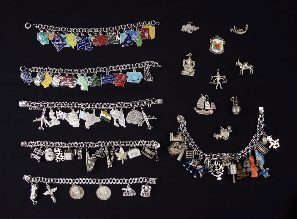 ESTATE LOT OF STERLING CHARM BRACELETS & CHARMS: ESTATE LOT OF STERLING CHARM BRACELETS & CHARMS: 6 multi link bracelets, 5 of which are stamped Sterling. Two filled with state charms, all marked Sterling. Most of the other charms are marked Sterlin