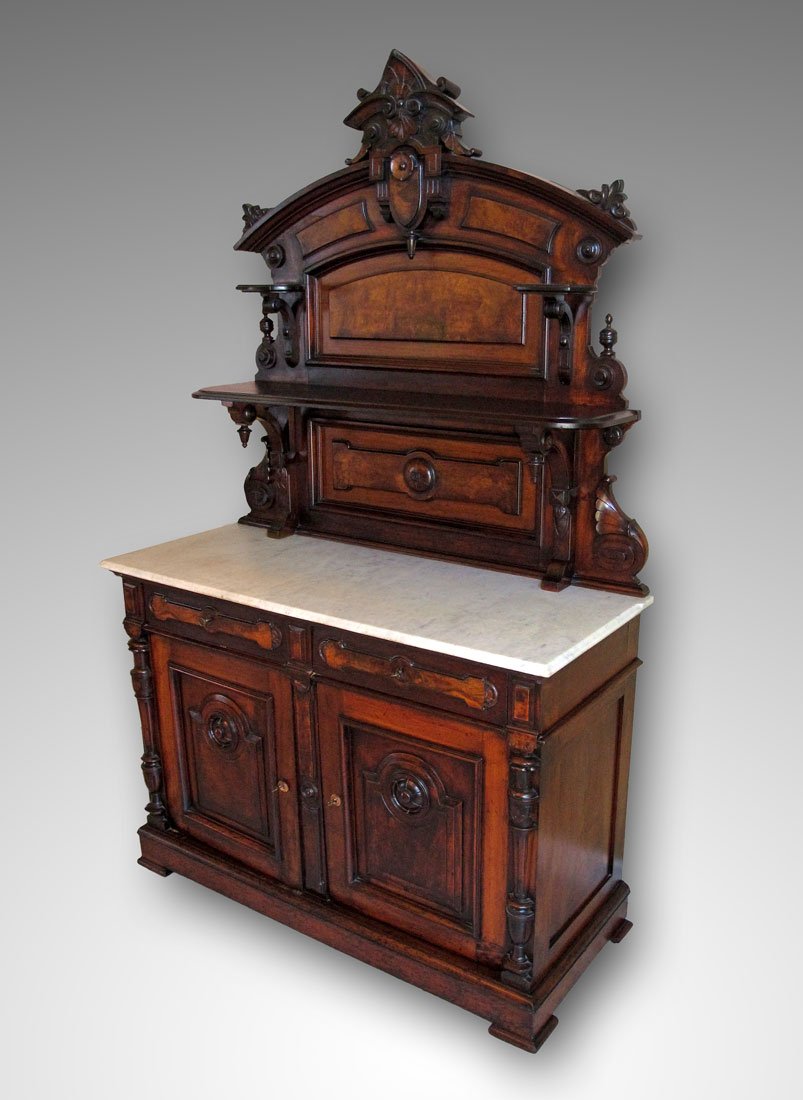 HIGH VICTORIAN MARBLE TOP SERVER: HIGH VICTORIAN MARBLE TOP SERVER: High Victorian style, carved crest with applied decoration, 2 candle stands, full length shelf with carved supports. Base with white marble top over 2 half-length dra