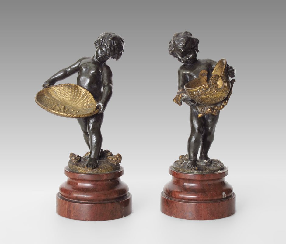 PAIR OF BRONZE CHERUBIC FIGURES SIGNED AUG. MOREAU: PAIR OF BRONZE CHERUBIC FIGURES SIGNED AUG. MOREAU: Circa first quarter 20th C., 4 1/2" h., affixed to pigeon blood red beveled matching plinths, 6" overall, incised signature in the bronze.