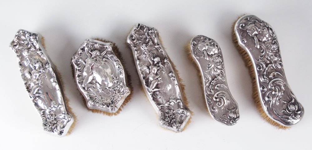 5 MAUSER STERLING MOUNTED BRUSHES: 5 MAUSER STERLING MOUNTED BRUSHES: To include 1) 3 brushes in the ''La Vision'' pattern, 2 cloth, 1 military. 2 monogrammed with Mauser markings, other simply marked Sterling. 2) 2 cloth brushes marke