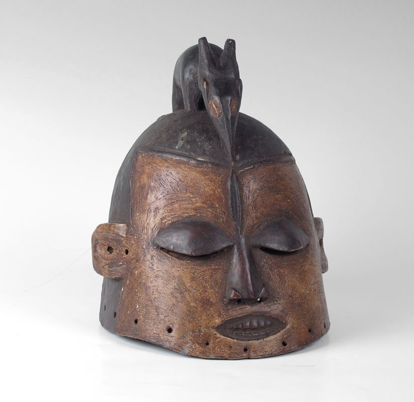 AFRICAN CARVED WOOD MASK: AFRICAN CARVED WOOD MASK: Surmounted by an ant eater type creature. Approx. 12" tall 9.5" dia.
