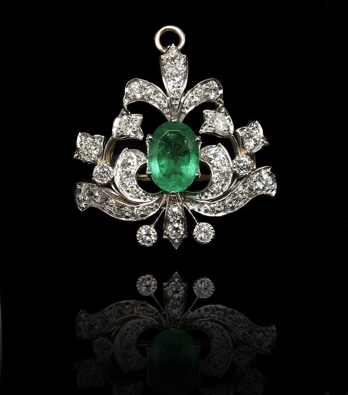 EDWARDIAN EMERALD & DIAMOND BROOCH PENDANT 14 GOLD: 2.20 CT EMERALD AND 2 CTW DIAMOND PENDANT / BROOCH CA. 1910-1920: 14k yellow and white gold diamond pendant centers an oval mixed cut emerald, approx. 2.20 Ct., VS2 clarity. The 35 Old European round 