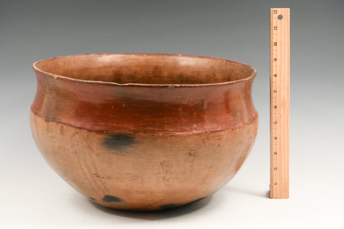 LARGE SAN JUAN PUEBLO POTTERY BOWL: LARGE SAN JUAN PUEBLO POTTERY BOWL: A large San Juan Redware bowl of clay pottery. This red-over-tan plainware deep bowl has a wide form and opening; traditional San Juan details include polished natu