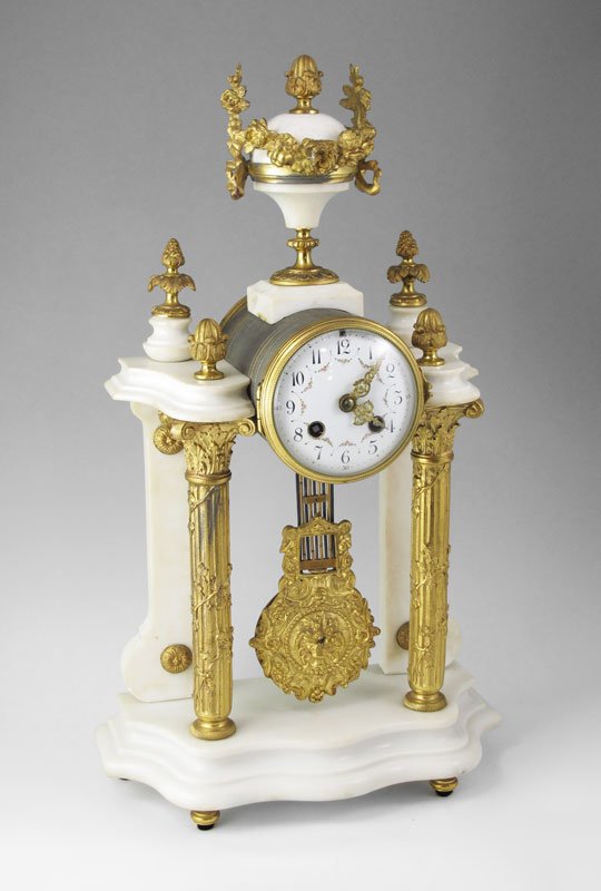 FRENCH MARBLE AND ORMOLU PORTICO MANTLE CLOCK: FRENCH MARBLE AND ORMOLU PORTICO MANTLE CLOCK: Urn finial with elaborate garland decoration. Porcelain face with painted garland. AD. Mougin time and strike movement, decorative pendulum. Marble and o