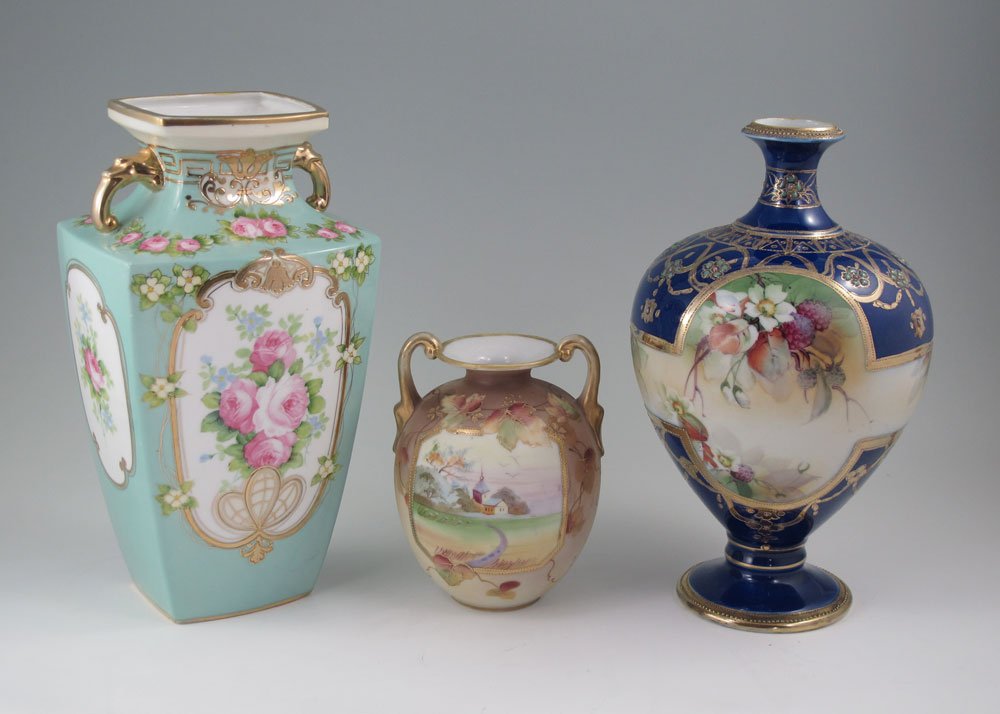 3 NIPPON PORCELAIN VASES: 3 HAND PAINTED NIPPON PORCELAIN VASES: 1) Bottle neck vase, cobalt ground with gold and enamel beading, oak leaf mark, 9 1/4" tall. 2) Aqua square body vase with reserves of roses, dragon head handles