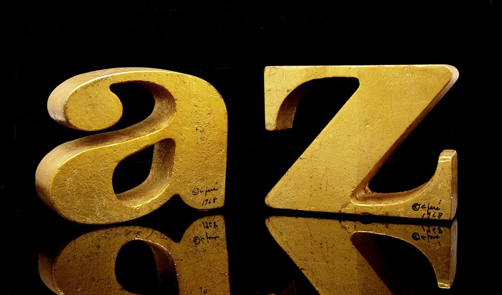CURTIS JERE SIGNED A-Z BOOKENDS: CURTIS JERE SIGNED A-Z BOOKENDS: Heavy cast metal with gilt finish. Signed C. Jere and dated 1968. Measures 4 1/2'' x 5 3/4'' x 1 5/8''.