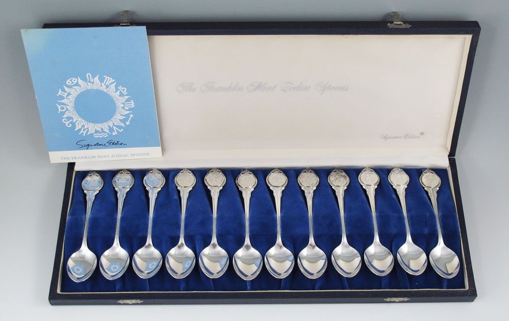 FRANKLIN MINT STERLING ZODIAC SPOON SET: FRANKLIN MINT STERLING ZODIAC SPOON SET: Signature Edition by The Franklin Mint, 12 apostle spoons, each displaying a sign of the Zodiac, by 6 different designers. Sold with original presentation box.