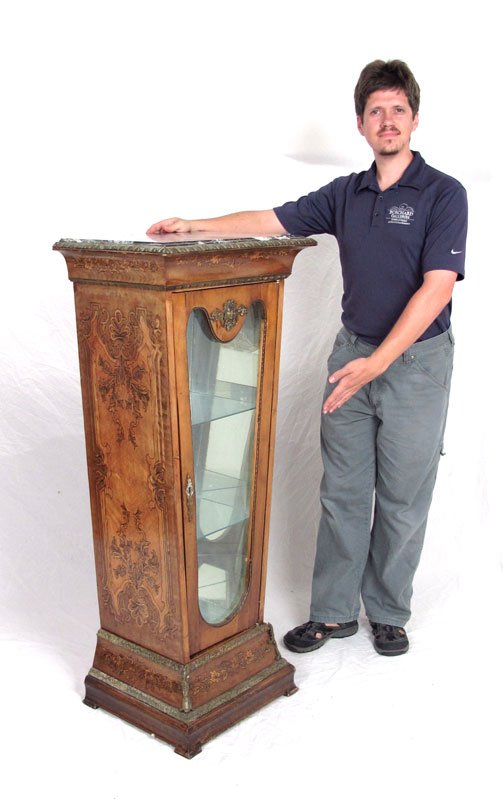 FRENCH STYLE PEDESTAL CURIO DISPLAY STAND: FRENCH STYLE PEDESTAL CURIO DISPLAY STAND: Marble top on a columnar glass front display stand. Painted faux inlay design. Gilt metal mounts. Measures approx. 50" tall x 23" x 15".