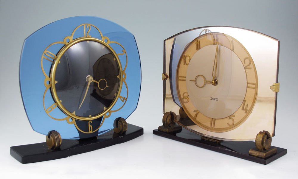 2 ENGLISH ART DECO CLOCKS: 2 ENGLISH ART DECO CLOCKS: To include 1) Unmarked as to maker but most likely Smiths, blue glass dial, japanned metal frame. Partial Made In England mark visible under loss of japanned metal finish. M