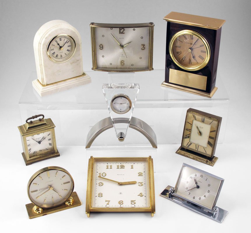 COLLECTION OF 9 TRAVEL & DESK CLOCKS: COLLECTION OF 9 TRAVEL & DESK CLOCKS: To include 1) Relid 7 Jewel travel clock, 3 3/4" h. 2) Benrus desk clock, 2" h. 3) Bulova carriage clock, 3 7/8" h. 4) Howard Miller presentation desk clock, quar