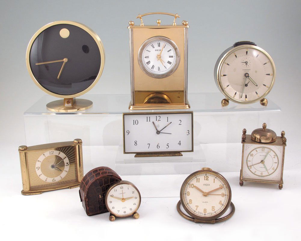 COLLECTION OF 8 TRAVEL & DESK CLOCKS: COLLECTION OF 8 TRAVEL & DESK CLOCKS: To include 1) Waltham travel clock, 3 3/4" h. 2) Junghans Trivox travel clock, 4 1/4". 3) Seiko quartz movement desk clock, 6". 4) Angelus travel clock, 2 3/4" h.