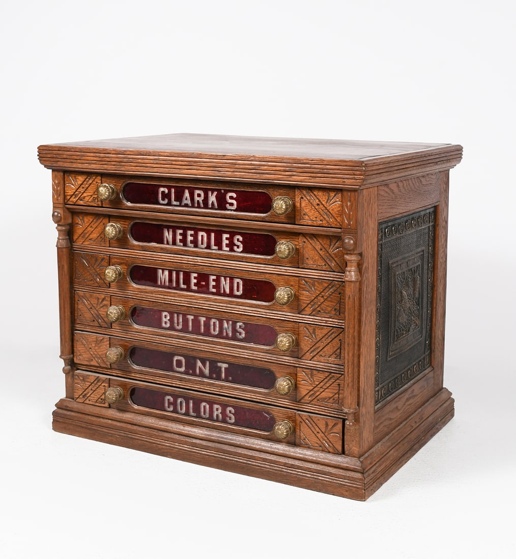 CLARK'S FURNITURE QUALITY SPOOL CHEST IN OAK: CLARK'S FURNITURE QUALITY SPOOL CHEST IN OAK W/ DECALS AND EMBOSSED TIN SIDES: Unusual antique furniture quality spool cabinet with embossed tin sides, decal to back panel, six drawers with incised de
